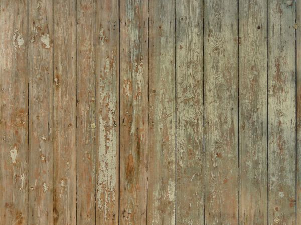 Rustic vertical planks with peeling paint.